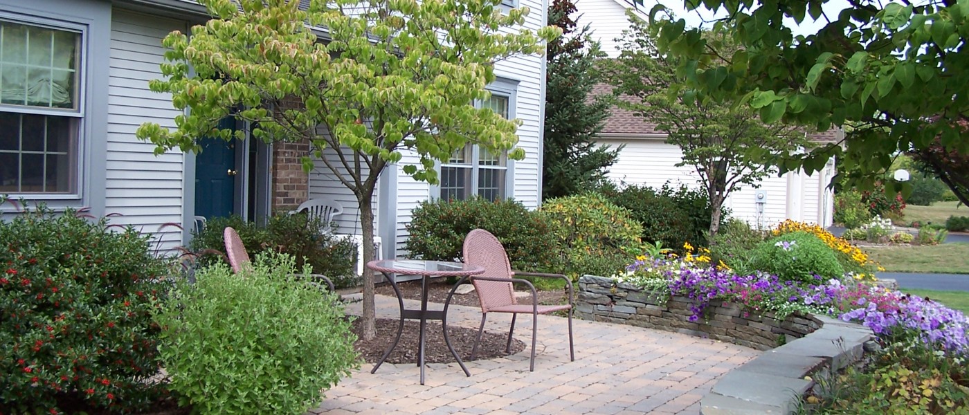 Sitting wall and patio by Broccolo Tree and Lawn Care